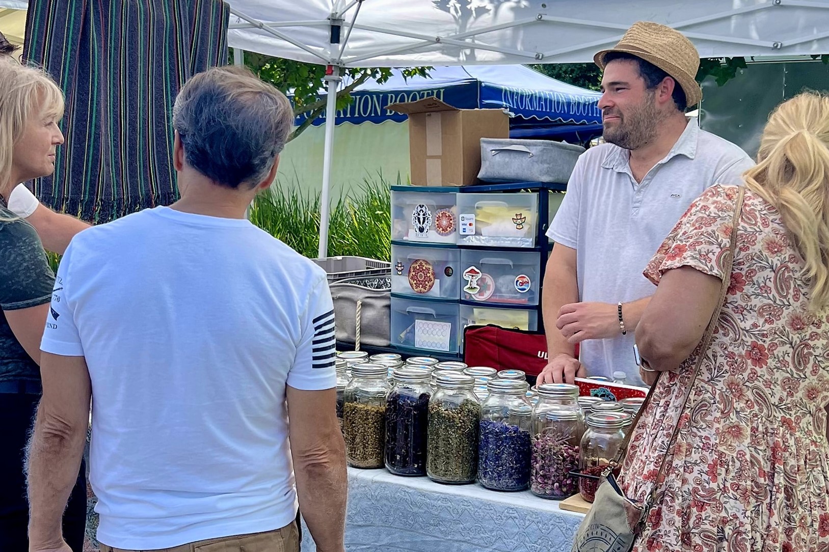 Man helping customer with spices.