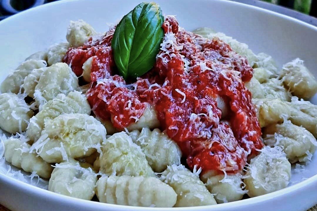 Gnocchi on a plate with sauce.