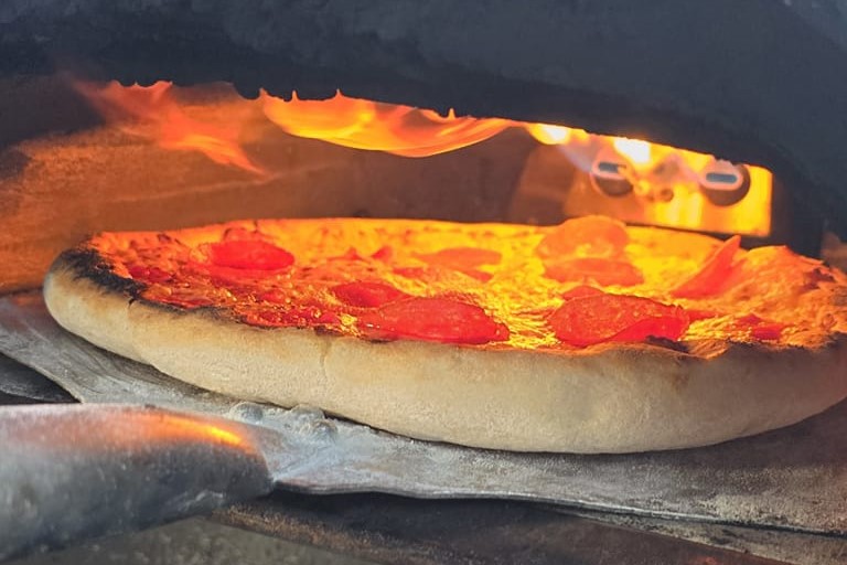 Pizza cooking in an oven.