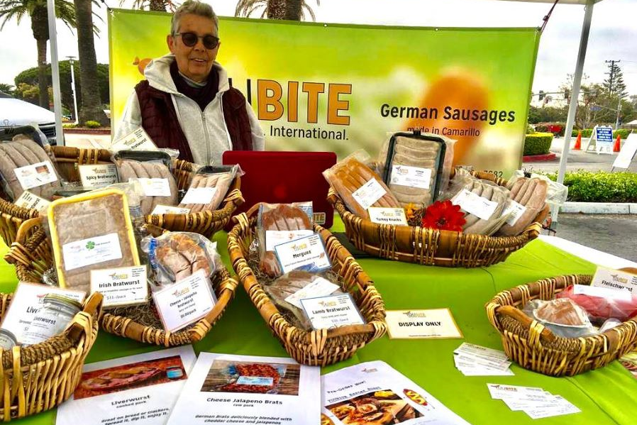 Woman with a table of German sausages.